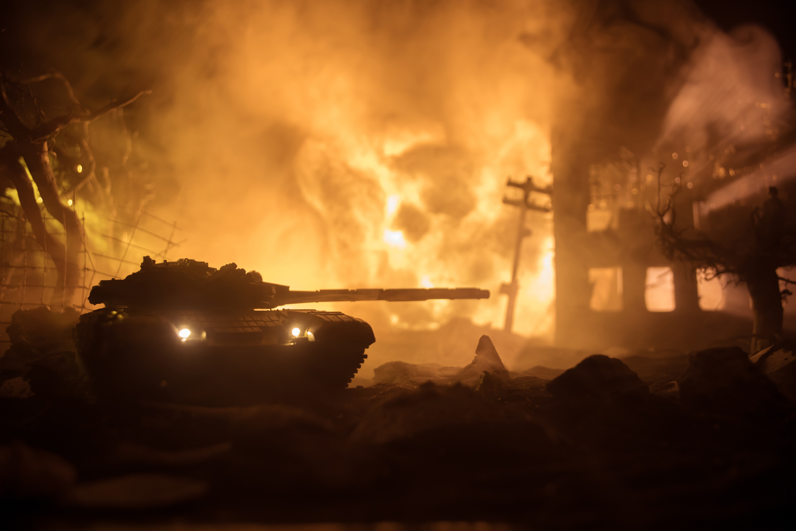 War Concept. Military silhouettes fighting scene on war fog sky background, World War Soldiers Silhouette Below Cloudy Skyline At night. Battle in ruined city.